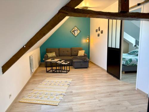 a living room with a couch and a table at Bienvenue chez Marie et Guillaume in Carentan