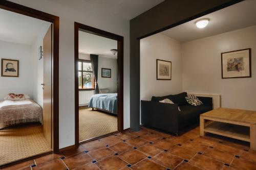a living room with a mirror and a bed at Hotel Kriunes in Reykjavík