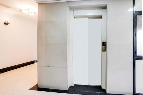 an open door in a room with white walls at Super Townhouse Margao Near Railway Station Formerly Hotel Tanish in Goa