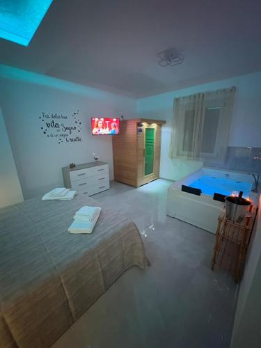 a bedroom with a large bed and a tub at IL SOGNO luxury house in Santa Tecla