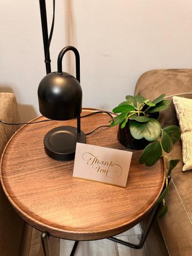 a wooden table with a round table with a sign on it at East Coast Cozy by Wastis-Easy Hwy, City & Airport Access plus Free Parking in Lower Sackville