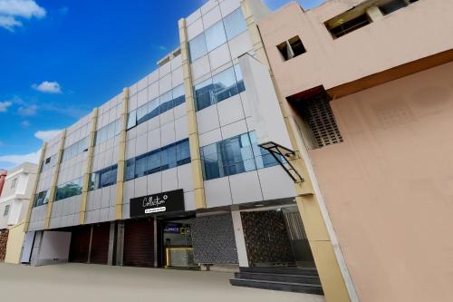a building with a sign on the side of it at Super Collection O Vadapalani Metro Station Formerly Pineapple Guest House in Chennai