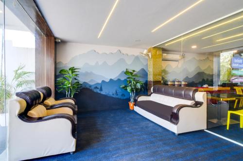 a hotel room with a mountain mural on the wall at Super Townhouse Shamshabad Paradise Formerly Blue Petals Hotel in Shamshabad