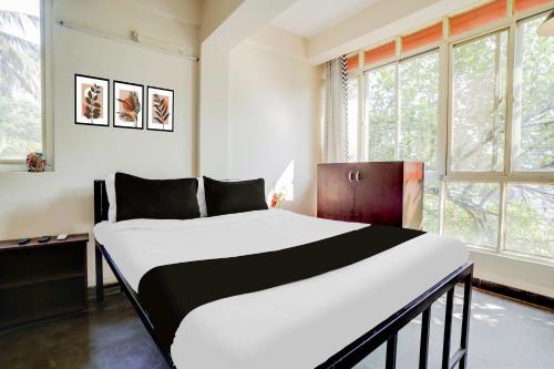 Postel nebo postele na pokoji v ubytování Super Hotel O Anjuna