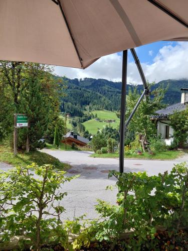 a view from a patio with an umbrella at Tauernlodge Sonnblick Top 2 in Mühlbach am Hochkönig