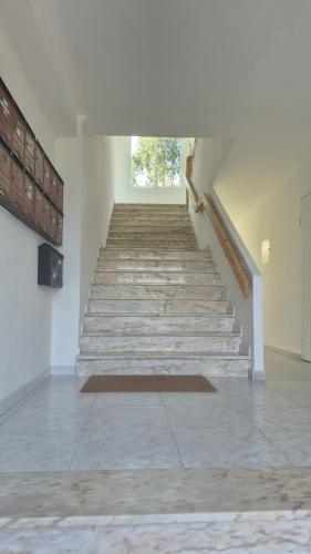 a stairway in a building with a window at Apartamento Soleado cerca de la playa - WIFI in Fisterra