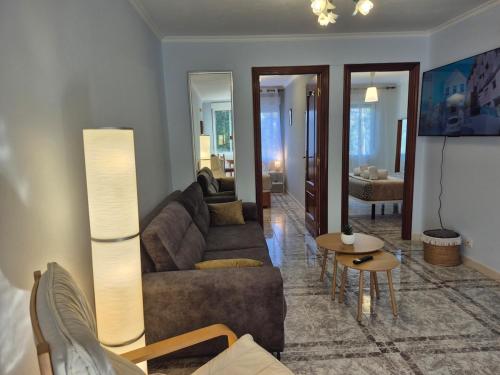 a living room with a couch and a table at Apartamento Soleado cerca de la playa - WIFI in Fisterra