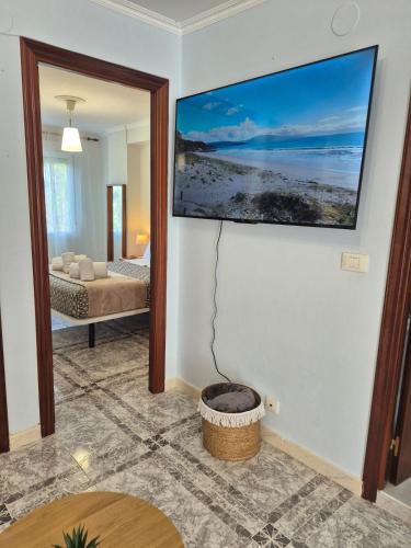 a room with a living room with a fire pit at Apartamento Soleado cerca de la playa - WIFI in Fisterra
