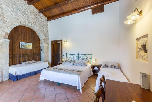 Кровать или кровати в номере La Muraglia Residenza Turistica Rurale