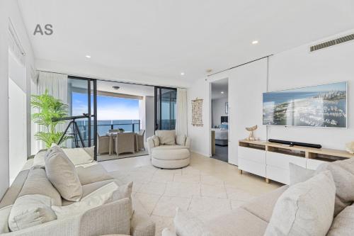 a living room with a couch and a tv at Soul - Private Apartments - Apartment Stay in Gold Coast