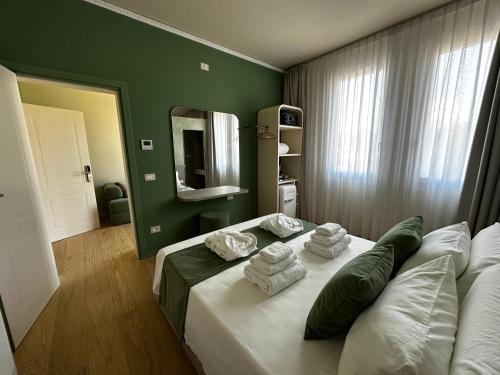 a hotel room with a bed with towels on it at Villa Margherita in Padova