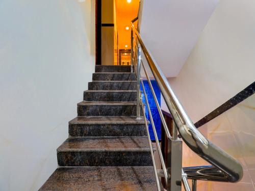 a staircase in a building with a stair railing at Super Townhouse Bellandur Near Embassy Tech Village in Bengaluru