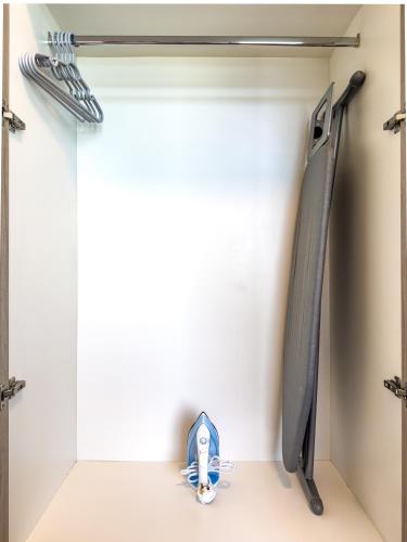 a shelf in a closet with a shoe in it at Great Fully Equipped 1BDR Apartment in Masdar for 4 Pax in Abu Dhabi