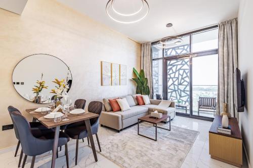 a living room with a couch and a table at Great Fully Equipped 1BDR Apartment in Masdar for 4 Pax in Abu Dhabi