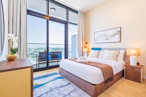 a bedroom with a large bed and a large window at Great Fully Equipped 1BDR Apartment in Masdar for 4 Pax in Abu Dhabi