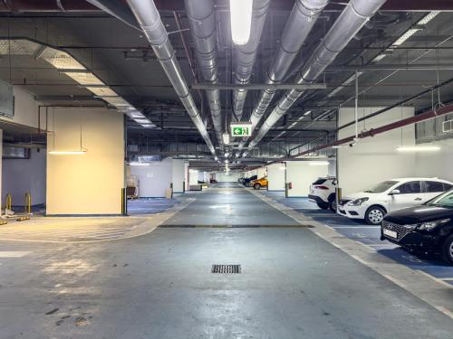 an empty parking garage with cars parked in it at Great Fully Equipped 1BDR Apartment in Masdar for 4 Pax in Abu Dhabi