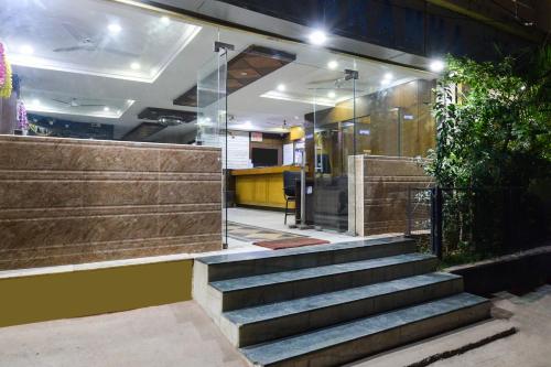 a lobby with stairs in front of a building at Townhouse OAK Secunderabad Near Railway Station Formerly Hotel Brahma in Hyderabad