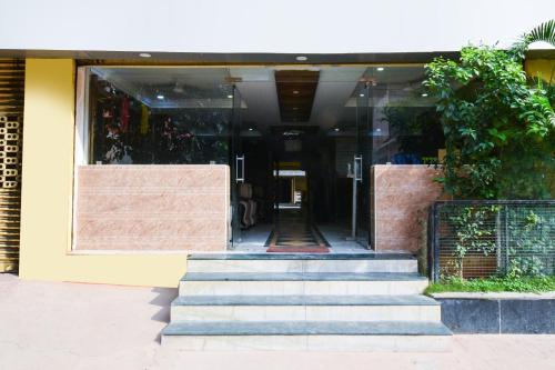 a building with stairs in front of a building at Townhouse OAK Secunderabad Near Railway Station Formerly Hotel Brahma in Hyderabad