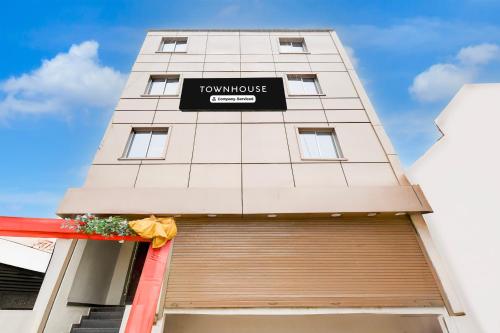 a tall building with a sign on it at OYO Townhouse Civil Lines Prayagraj Formerly Raj Mahal Palace in Civil Lines