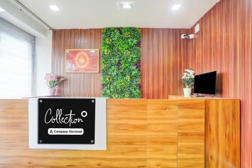 an office with a sign on a reception desk at Super Collection O Chikmagalur Market Road in Chikmagalūr
