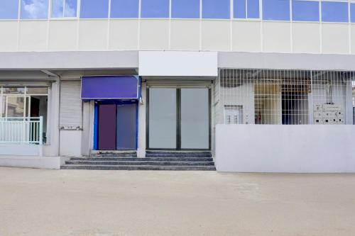 a building with doors and stairs in front of it at Super Collection O Chikmagalur Market Road in Chikmagalūr