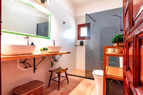 a bathroom with two sinks and a shower at Edomus Castillo de las Guardas in Seville