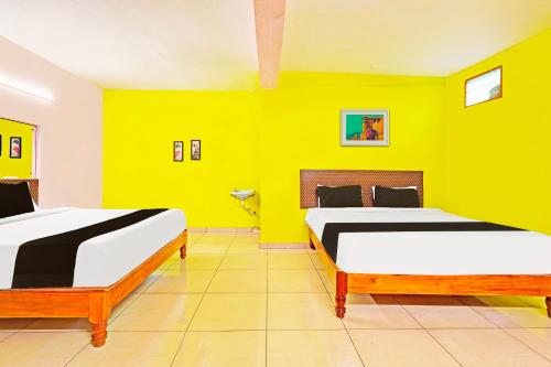 Ένα ή περισσότερα κρεβάτια σε δωμάτιο στο Super Hotel O Thavalakuppam Bus Stand Formerly Le Sai