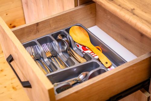 a drawer with scissors and other utensils in it at Green Paradise Martvili Cottege in Martvili