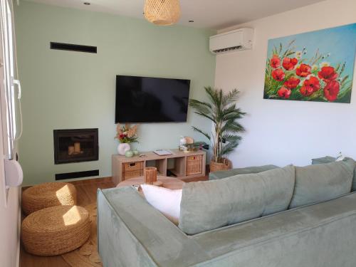 a living room with a couch and a flat screen tv at Sandy Ridge in Kalamaki Heraklion