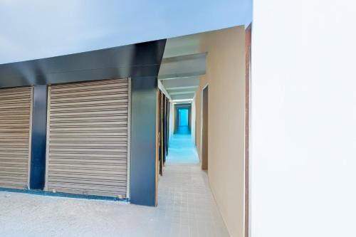a hallway of a building with closed garage doors at Super Collection O Kolkata Near Dumdum Airport in kolkata