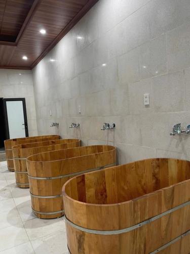 a row of wooden barrels in a room with at Đầm sen Resort in Hòa Lạc