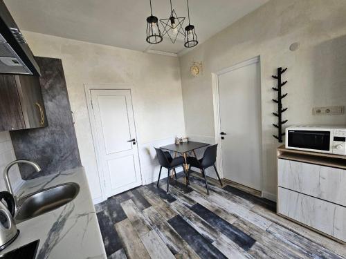 a kitchen with a table and chairs in a room at Loft Comfort House in Yerevan in Yerevan