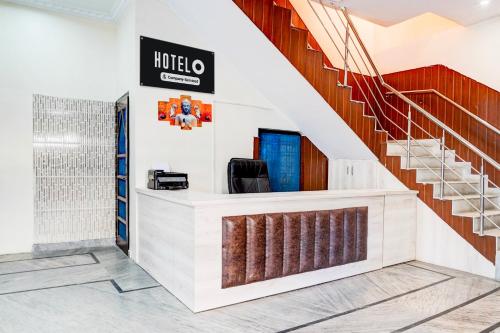 a lobby of a hotel with a staircase at Super Hotel O Sudhowala Near Nanda ki Chowk in Dehradun