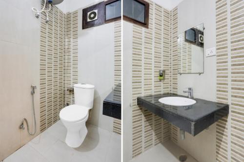 a bathroom with a toilet and a sink at Super Collection O Gol Park Atala in Prayagraj