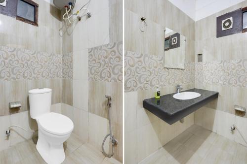 a bathroom with a toilet and a sink at Super Collection O Gol Park Atala in Prayagraj