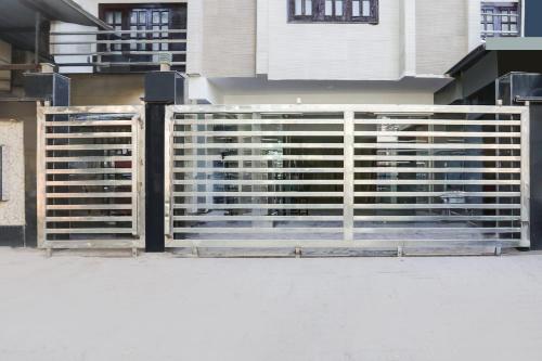 a fence in front of a house with a building at Super Collection O Gol Park Atala in Prayagraj