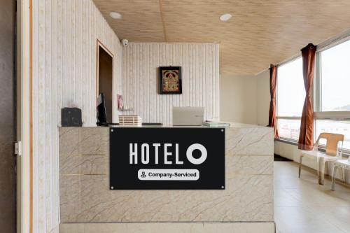an office with a hotel sign on a wall at Super Hotel O Machilipatnam in Machilīpatnam