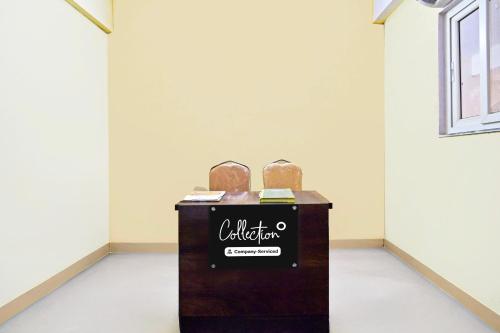 a exhibit in a white room with two artifact boxes at Collection O Jagadgirigutta Road in Hyderabad