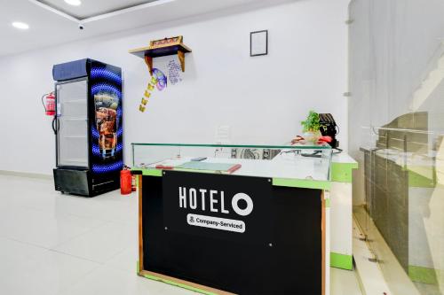 a ticket booth in a room with a hotel sign on the wall at Super Hotel O Moula Ali Neredmet in Hyderabad