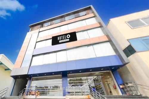 a building with a hotel sign on it at Super Hotel O Moula Ali Neredmet in Hyderabad