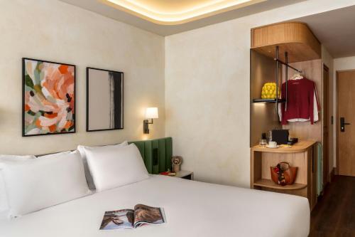 a bedroom with a white bed and a wardrobe at Salitre Hotel, Sonder by Marriott Bonvoy in Málaga