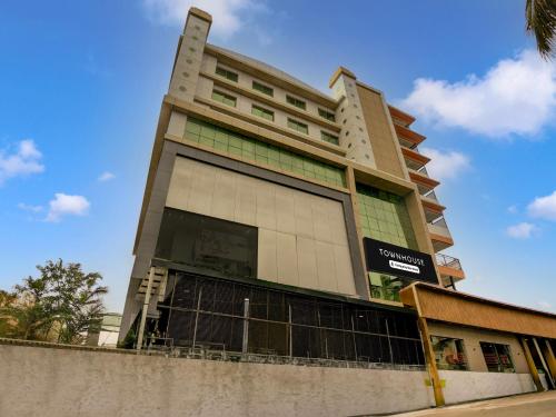 a tall building with a sign in front of it at Super Townhouse Madgaon in Goa