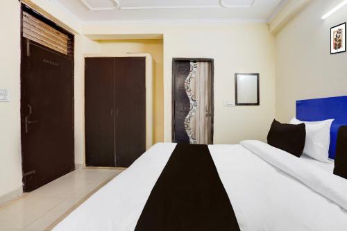 a bedroom with a bed with a black and white at Super Hotel O Sheetla Colony in Gurgaon