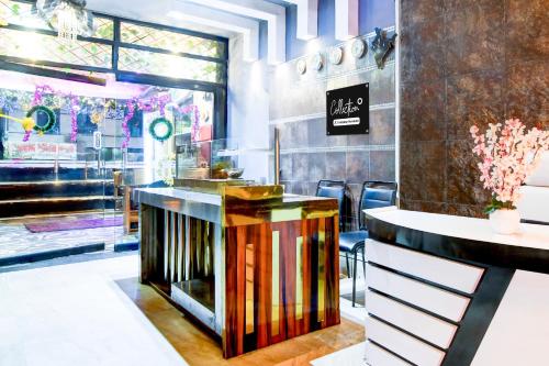 a bar in a restaurant with a counter at Super Collection O Circus Avenue Road Formerly Hotel Rockstar in Kolkata