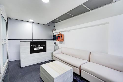 a living room with a couch and a table at Super Townhouse Sector 135 Noida in Noida