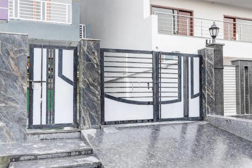 an open gate in a house with stairs at Super Townhouse Sector 135 Noida in Noida