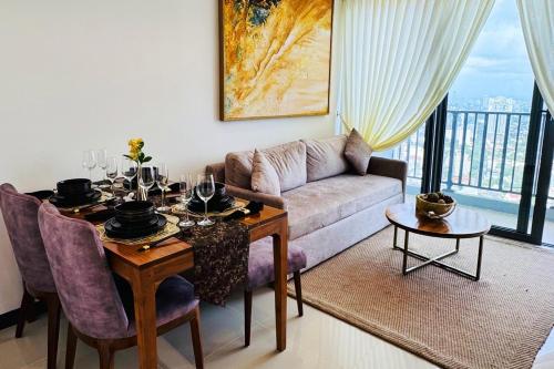 a living room with a table and a couch at YAKA Trizen Luxury Apartments - 53rd and 51st Floor with Stunning Views in Colombo