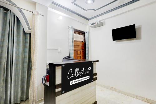 a room with a television and a sign on the wall at Super Collection O Nagwa Lanka Varanasi in Varanasi