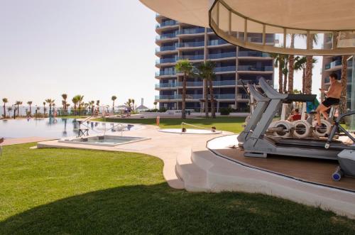 a person on a exercise machine in front of a building at Sea Senses by Mar Holidays in Torrevieja