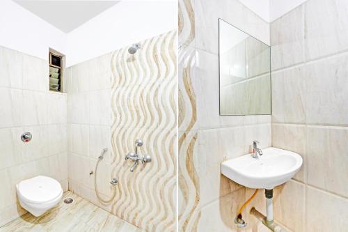 a bathroom with a sink and a toilet at Super Hotel O Rane Nagar formerly Shree Mangal Complex in Nashik